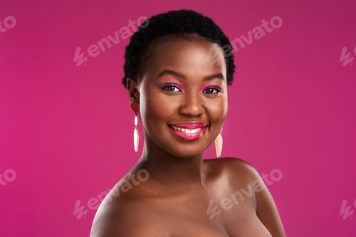 Preview: Studio shot of a beautiful young woman posing against a pink background