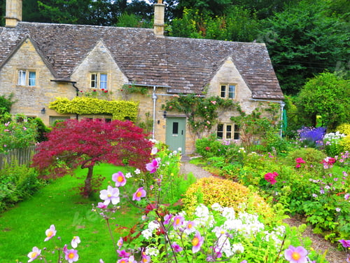 Preview: Garden and house in UK style. Front of English House. Scenic View of Colorful Flowerbeds and an Attr