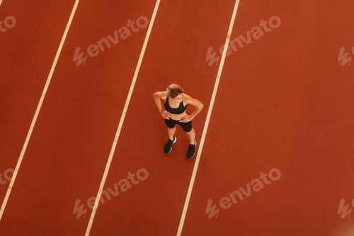 Preview: young blonde beautiful sportswoman training on athletic stadium
