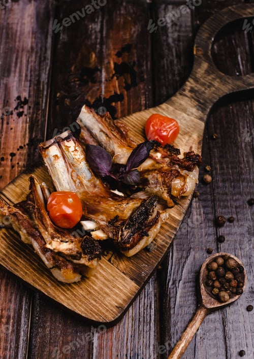 Preview: close-up shot of delicious grilled ribs on wooden cutting board