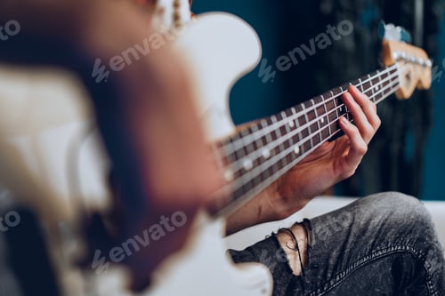Preview: Close up photo of male hands playing guitar