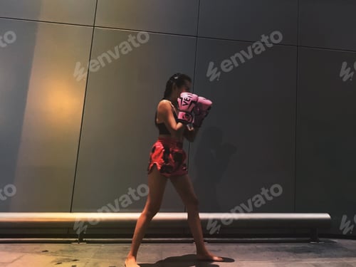 Woman Practices Boxing Moves Wearing Pink Gloves