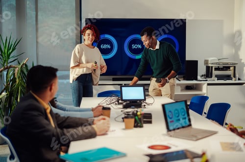 Preview: Hispanic woman and african american man having fun while speaking at meeting