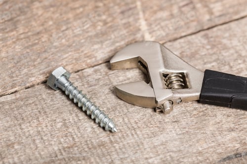 Preview: Tools used for home repair on a wooden surface during daylight hours