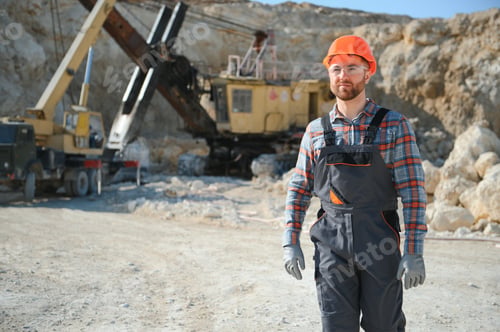 Preview: Extraction of stone. Male worker next to stone quarry. Engineer at construction site