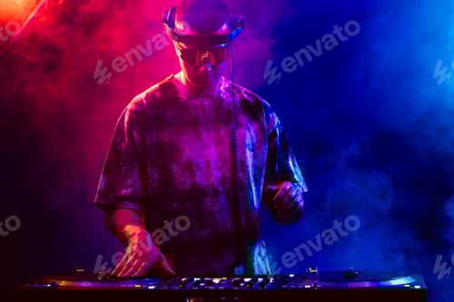 Preview: Club DJ playing music at party wearing sunglasses
