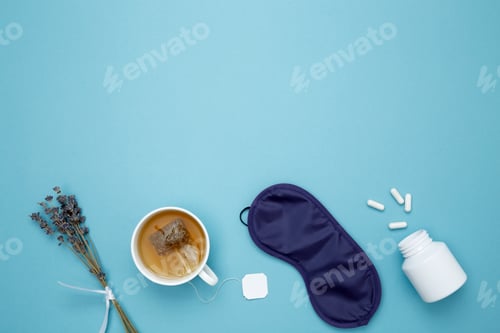 Preview: Sleep essentials eye mask, tea, pills, clock. Concept of relaxation and rest, insomnia treatment