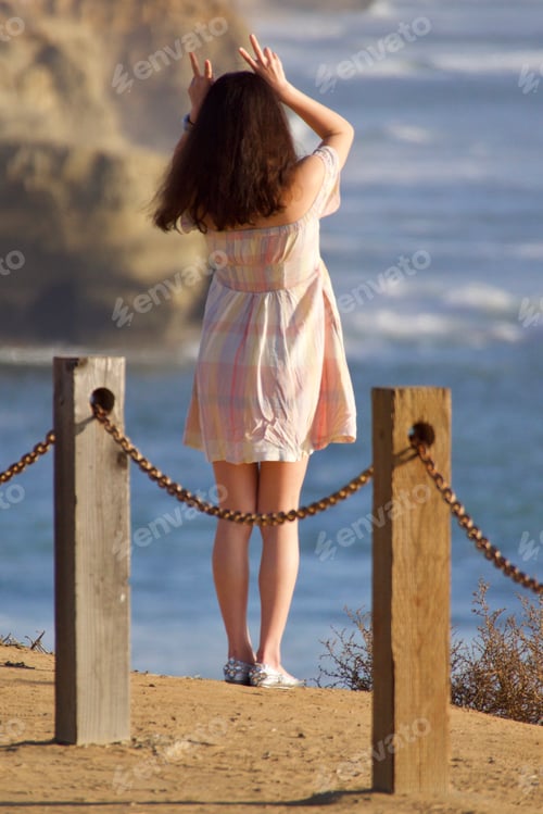 Preview: Woman on vacation on a cliff overlooking the Pacific. tonythetigersson, Tony Andrews Photography