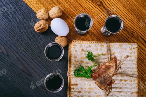 Preview: Red kosher four glasses wine with a of matzah a Passover Haggadah on a vintage wood background