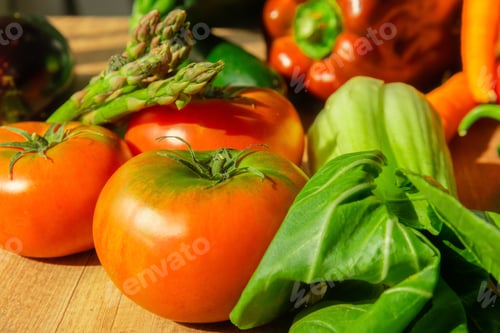 Preview: Closeup of ripe tomatoes with herbs on a wooden table