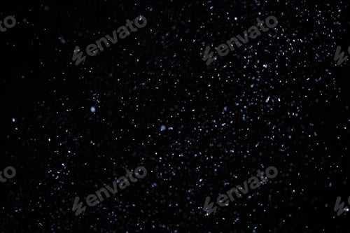 Preview: Snow flakes falling on black background. Winter weather