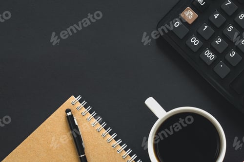 Preview: Calculator, cup of coffee and notebook on a black background, top view.