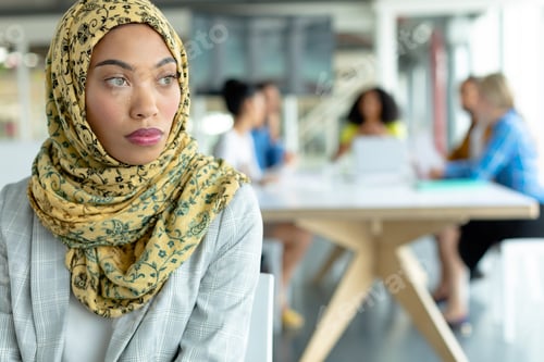 Preview: Thoughtful Mixed-race businesswoman in hijab looking away