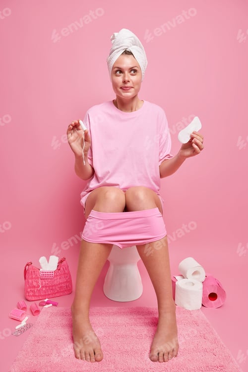 Preview: Full length shot of pretty thoughtful woman wears casual t shirt towel over head comfortable panties