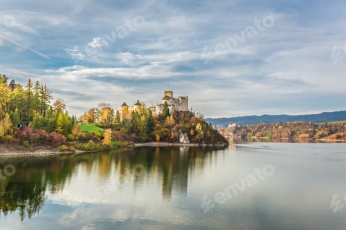 Preview: Beautiful castle by the lake at sunset in autumn