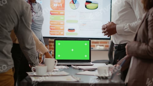 Preview: Colleagues working and using laptop with green screen on desk