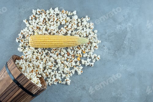 Preview: Uncooked corn plant with white popcorns around