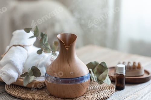 Preview: Spa composition with aroma oil diffuser lamp on a blurred background.