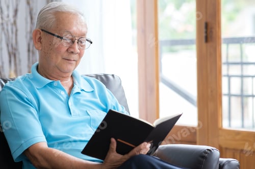 Preview: Senior man reading book and stay alone at home.