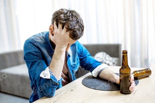Preview: Drunk male alcoholic with drinks at home