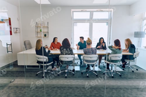 Preview: Diverse Business Team Discussing Projects in a Modern Glass Office.