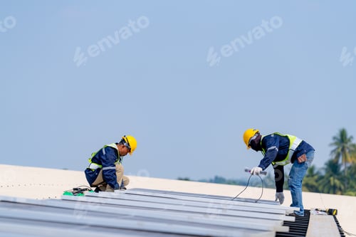 Preview: workers installing solar panels, for efficient energy on rooftop