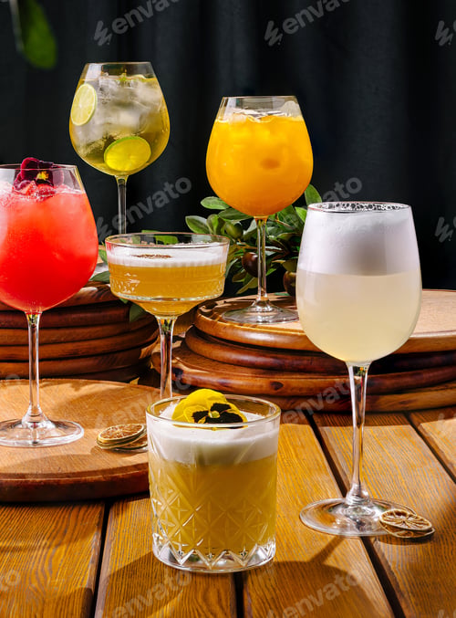 Preview: Colorful cocktails displayed on a wooden table at a vibrant bar setting