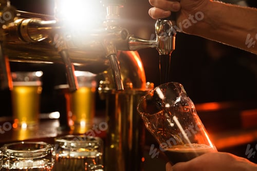 Preview: Close up of a bartender pouring beer