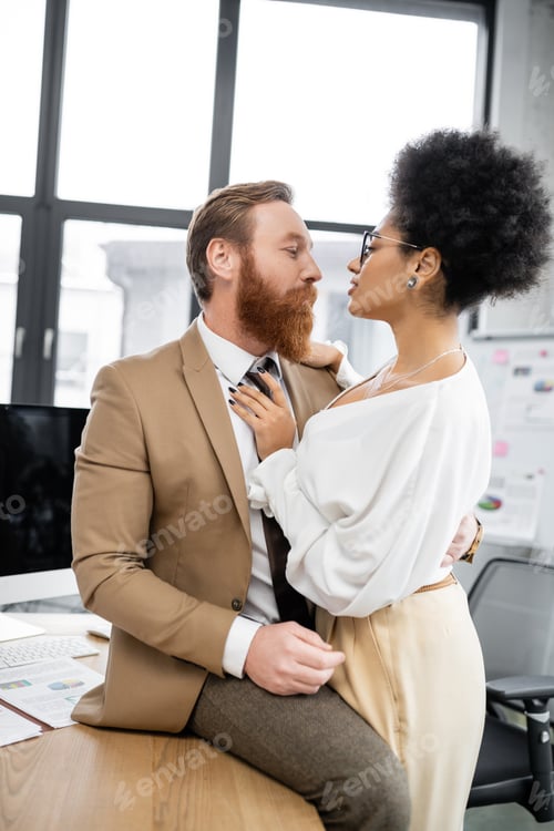 Preview: brunette african american woman seducing bearded businessman in suit