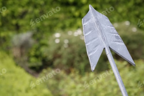 Preview: Metal arrow tip pointing left in spring, concept: target, focus, task orientation, use: background