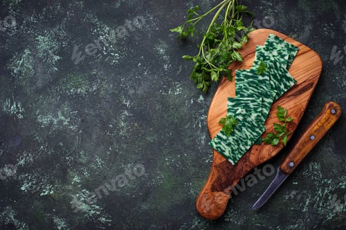 Preview: Green sliced cheese with herbs.