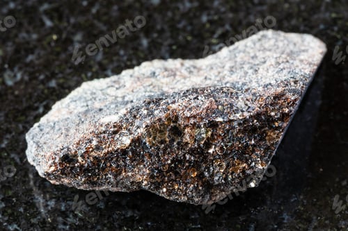 Preview: sample of raw phlogopite mica on black granite