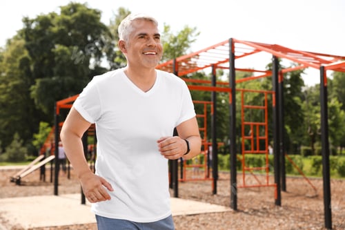 Preview: Handsome mature man running on sports ground, space for text. Healthy lifestyle