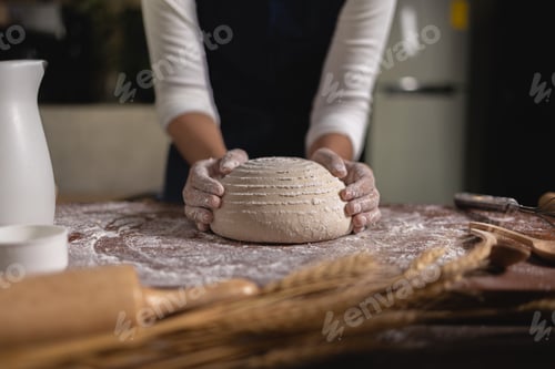 Preview: Close up Hand of baker chef is making with flour loaf of dough