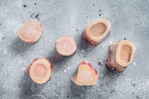 Preview: Raw calf Marrow bones on butcher table. Gray background. Top view