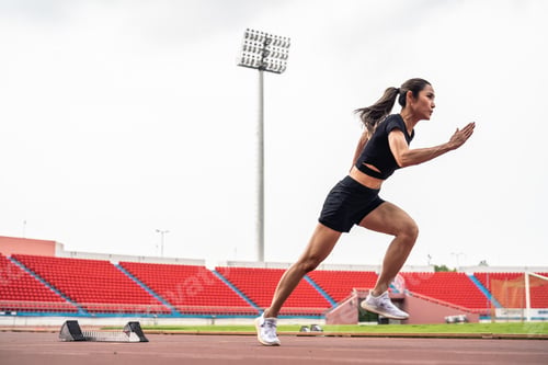 Preview: Asian young sportswoman sprint on a running track outdoors on stadium.