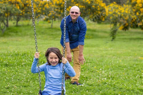 Preview: father-pushing-daughter-on-the-swing