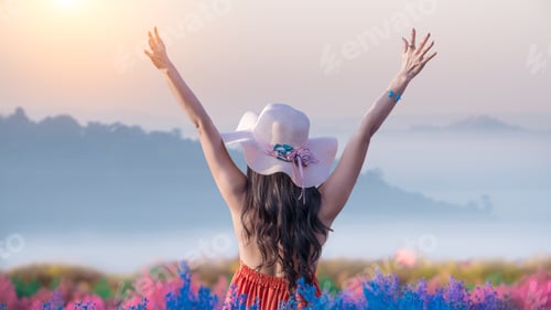 Preview: Beautiful woman wearing dresses and hat stand in floral flower boom field with nice nature white sof