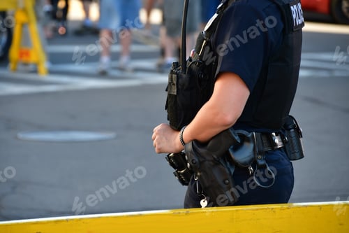 Preview: Female police officer standing guard behind a barricade. police officers, law enforcement