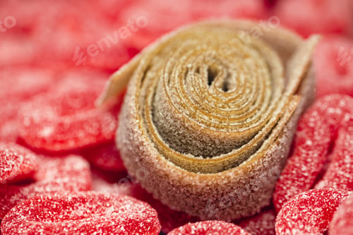 Preview: Red gummies jelly candies in sugar, background.