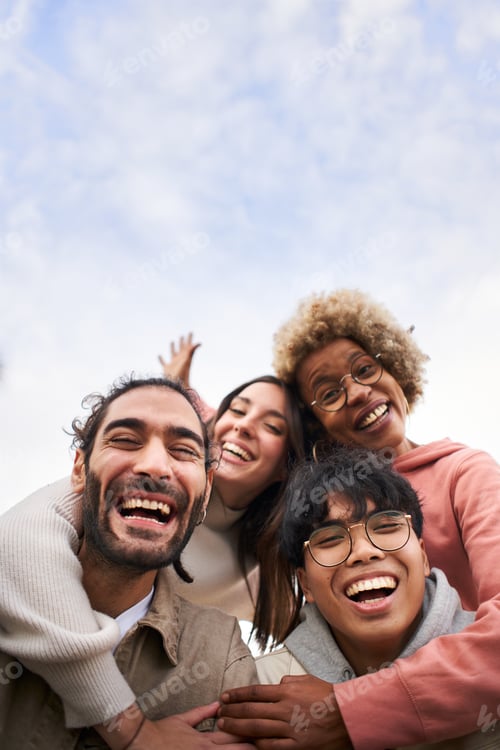 Preview: Vertical of a Group of young people looking at the camera outdoors.