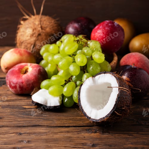 Preview: Concept of vegan food with coconut, grape, peache and plums