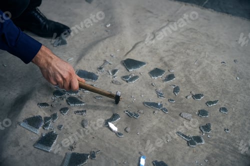 Preview: Man breaks triplex glass with a hammer