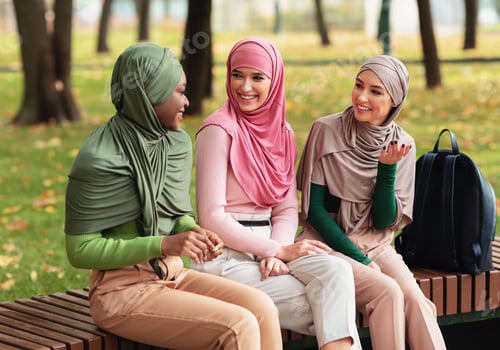 Preview: Three Modern Islamic Female Students Spending Time Chatting Outdoors