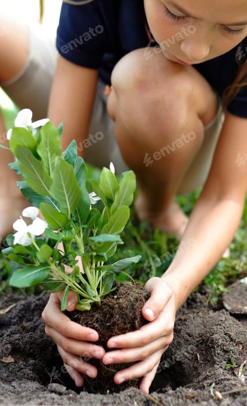 Preview: Young girl planting spring flowers in the garden
