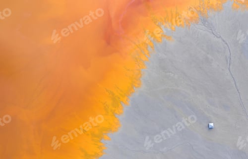 Preview: Aerial view of a toxic waste lake, with yellow chemical residuals flooded a church by drone