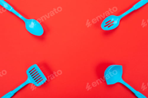 Preview: Close up picture of kitchen utensils with copyspace on red background