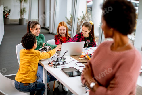 Preview: happy kids with their African American female science teacher with laptop