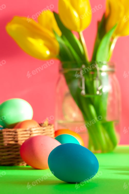 Preview: Vibrant colored eggs in a nest on green. Easter concept
