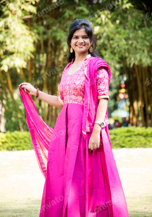 Preview: Outdoor portrait of beautiful young Indian girl in traditional dress.